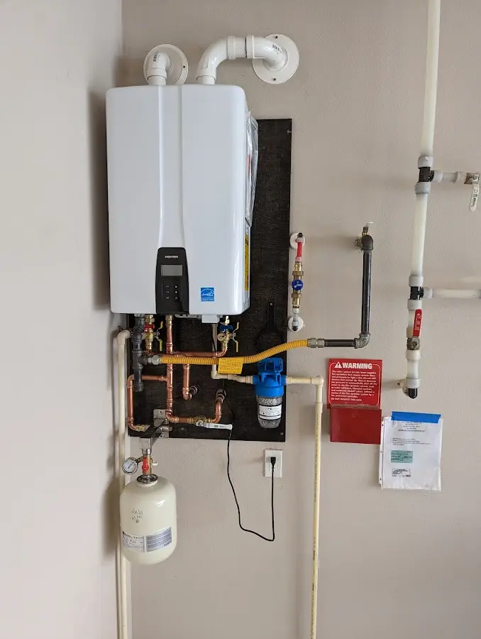 Professional plumber installing copper piping in a Lloyd home